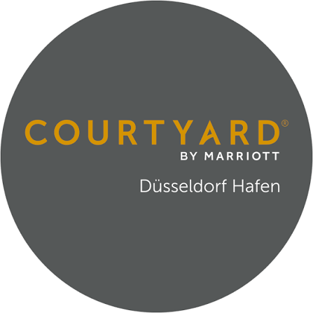 Dark gray circular Courtyard by Marriott Düsseldorf Hafen logo with gold COURTYARD and white BY MARRIOTT Düsseldorf Hafen text